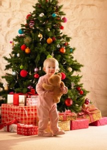 Little girl by the christmas tree