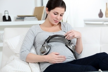 pregnant mom playing music for her baby