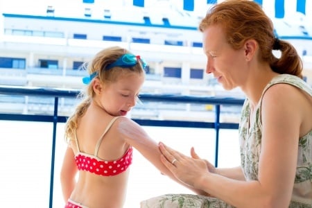 Mom applying sunscreen