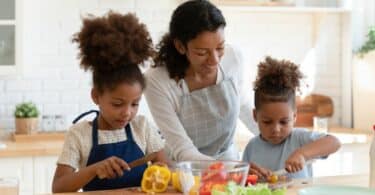 mom with kids cooking in the kitchen