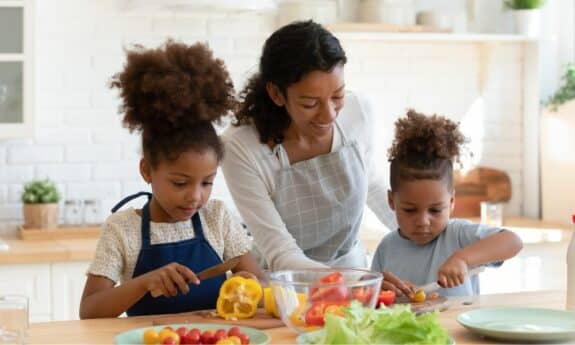 mom with kids cooking in the kitchen