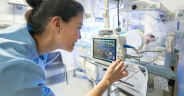 nurse looking after baby in NICU