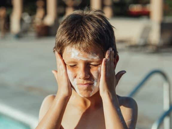 A Boy with Sunscreen on His Face