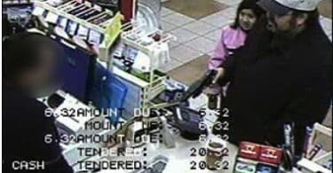 SURVEILANCE FOOTAGE OF DAD ROBBING STORE WITH DAUGHTER IN HIS ARMS.