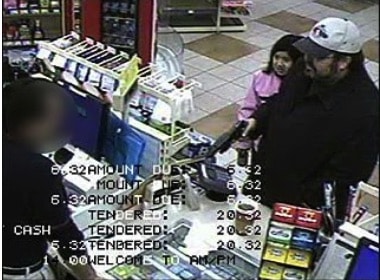 SURVEILANCE FOOTAGE OF DAD ROBBING STORE WITH DAUGHTER IN HIS ARMS.