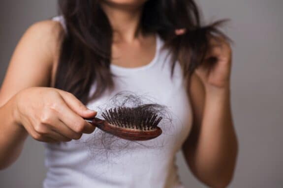 woman experiencing hair loss