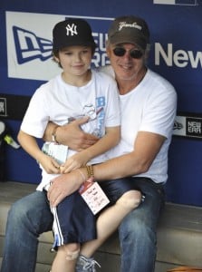 Richard Gere and son Homer James sit in the New York Yankees dugout prior to their game against the New York Mets at Citi Field in Flushing, NY