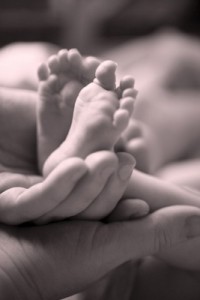 Parent holding baby's feet