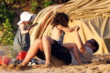 Adam playing on the beach with Sadie and Sunny