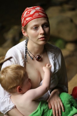 mom breast feeding an older child