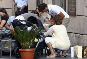 Roger and Mirka tuck one of their twins into their stroller