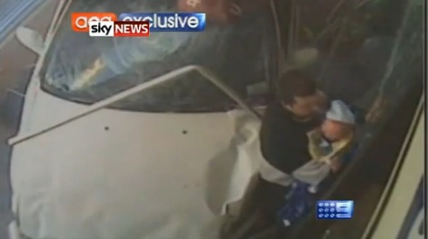 Dad and Baby Shown pinned by the car