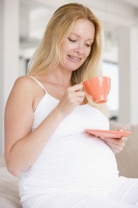 Expectant mom enjoys a cup of coffee