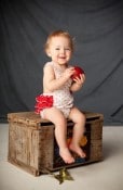 Nostalgic red and white vintage-inspired sun suit romper, with red ruffles