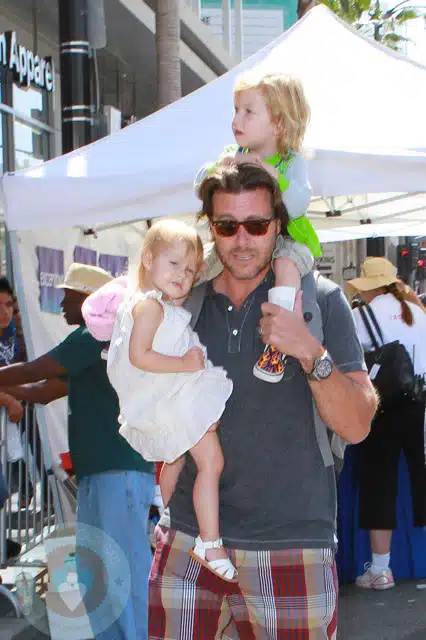 Dean McDermott carrying Stella and Liam