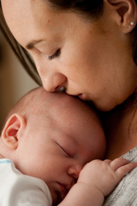 mom kissing baby