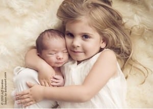 Big Sister Ella cuddles Baby Leo