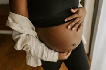 pregnant woman holding her belly