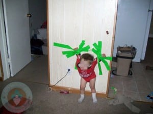 distressed toddler fixed to wall