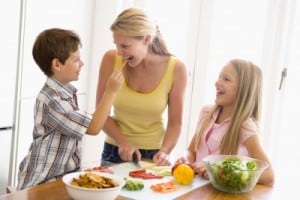 mom prepping dinner with her kids