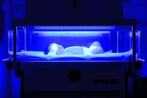 newborn having a treatment for jaundice under ultraviolet light in incubator