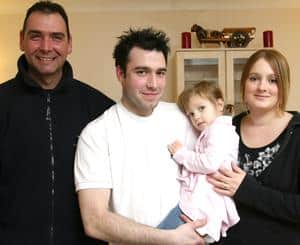 Rachel and Martin Drake with their daughter, Lucy and their neighbour, Deon Schroven (L)