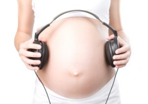 pregnant mommy playing her baby some music