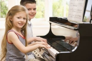 brother sister playing piano