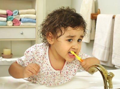 toddler brushing her teeth