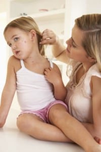 mom checking daughter with chicken pox