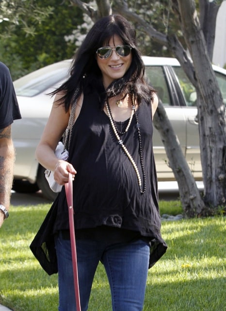A very pregnant Selma Blair strolls with her dog