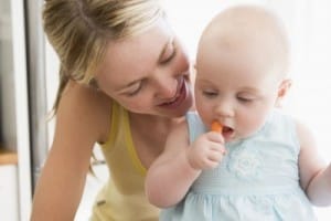 Mom and baby eating carrots