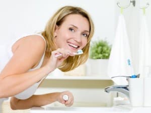 woman brushing teeth