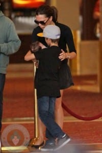 Romeo Beckham holds his sister Harper