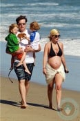 A pregnant Tori Spelling and Dean McDermott with their kids at the beach