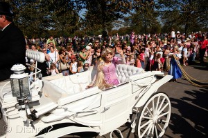 10,000 Disney fans waving flags and lining the parade route to welcome Rapunzel and the other Disney Princess characters in their horse-drawn carriages