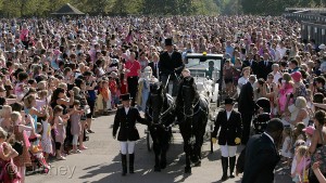 10,000 Disney fans waving flags and lining the parade route to welcome Rapunzel and the other Disney Princess characters in their horse-drawn carriages