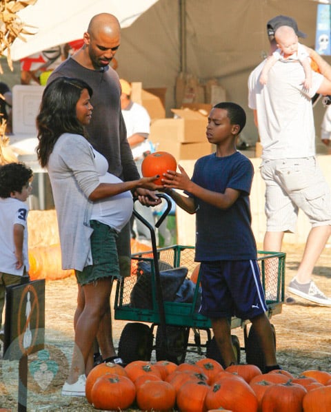 A very pregnant Nia Long with boyfriend Ime Udoka and son Massai, 11