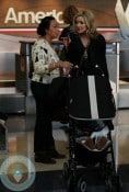 Jane Krakowski with son Bennet at the airport