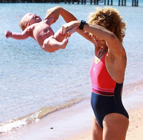 Russian therapist Lena Fokina swinging a newborn