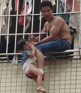 Chinese Father dangles toddler out of window