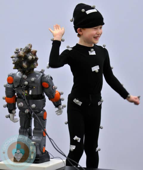 Anthony Arceri, 7, interacts with Zeno at UNT Center for Biohealth