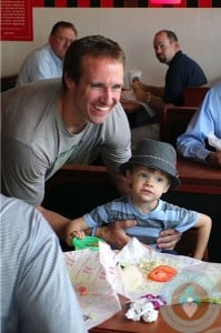 Drew Brees with son Baylen in New Orleans