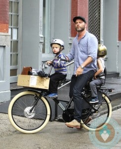 Liev Schreiber rides on a bike with his sons Sammy and Sasha in NYC