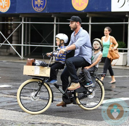 Liev Schreiber rides on a bike with his sons Sammy and Sasha