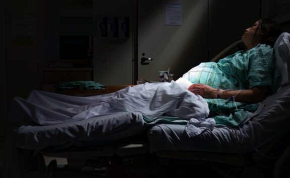 pregnant woman laying in hospital bed