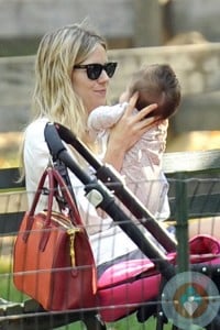 Sienna Miller cuddles daughter Marlowe in Central park