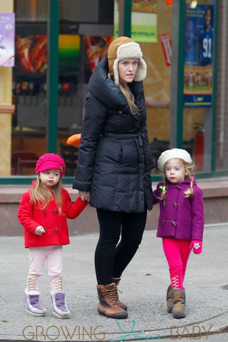 Jessica Parker's twin daughters Tabitha and Loretta Broderick wear colorful coats as they walk to school with their babysitter