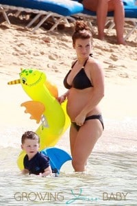 Coleen Rooney, wife of footballer Wayne Rooney, shows off her baby bump in a bikini as she plays with son Kai on the beach in Barbados