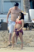 **EXCLUSIVE** Jenna Dewan shows off her blossoming baby bump in a bikini top as she frolics on the beach with husband Channing Tatum